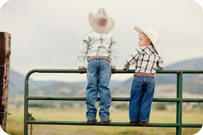 kids standing on fence